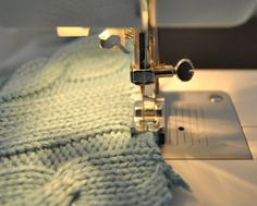 a close up of a sewing machine with the needle on it's side and stitching