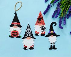 cross stitch halloween decorations on a blue background