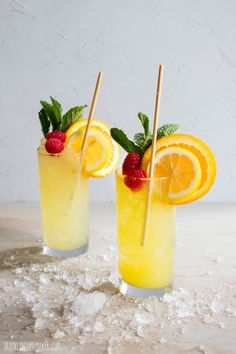 two glasses filled with lemonade and strawberries