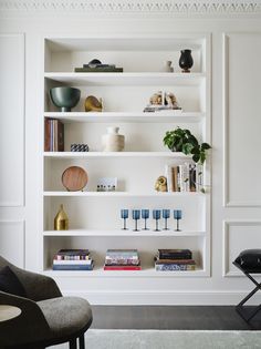 a white book shelf filled with lots of books