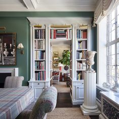 a living room filled with furniture and bookshelves