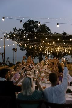 a group of people sitting around a dinner table