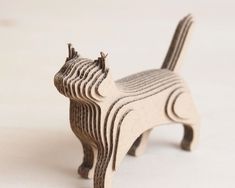 a small wooden cat figurine sitting on top of a table