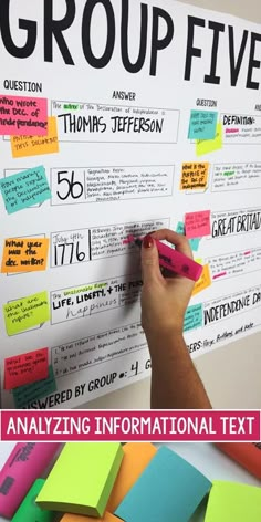 a person writing on a bulletin board with sticky notes