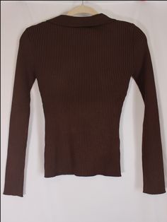 Effortless and classic brown ribbed knit top with stretchy material, long sleeves, v-neckline, and collar detail. details & fit: fits slightly small. 70% viscose, 30% polyester measurements: small: bust 26"/ waist 18"/ length 21" medium: bust 28"/ waist 20"/ length 21.5" large: bust 30"/ waist 22"/ length 22" model details: model is 5'7" and wearing size medium Classic Brown Ribbed Sweater, Brown Long Sleeve Turtleneck For Fall, Brown Ribbed Collar Turtleneck For Fall, Brown Long Sleeve Sweater With Ribbed Neckline, Brown Knit Sweater With Ribbed Neckline, Casual Brown Stretch Turtleneck, Brown Knit Top With Ribbed Collar, Brown Classic Long Sleeve Turtleneck, Classic Brown Turtleneck Top