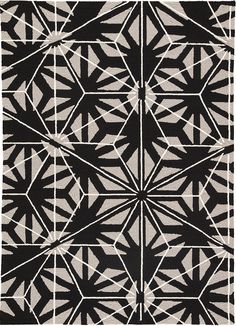 a black and white rug with an abstract design