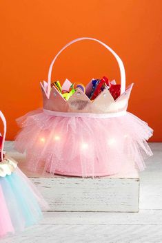 two small baskets filled with toys on top of a table