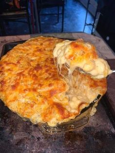 a dish with cheese being lifted from it