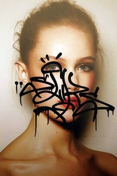 a woman's face is covered in graffiti