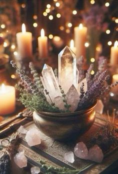 crystals and candles on a table with lights in the background