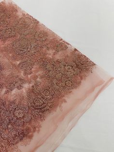 an image of a piece of cloth that is on the ground with it's lace edge