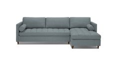 a gray couch with a chaise lounger on the bottom and footrests