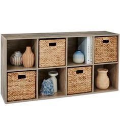 a shelf with wicker baskets and vases on it's sides for storage