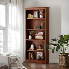 a living room with a large window and a book shelf