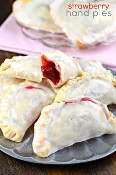 strawberry hand pies are sitting on a plate