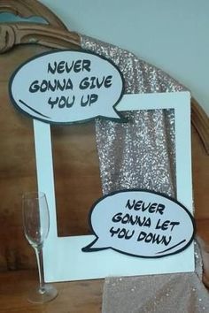 two speech bubbles are attached to a wooden frame with silver sequins on it