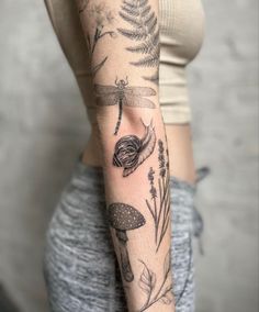 a woman's arm with tattoos on it