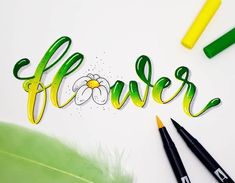 the word flower written in cursive writing next to some markers and pencils