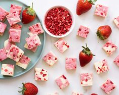 strawberry cheesecake fudges and strawberries on a plate