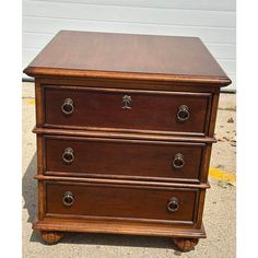 a wooden dresser with three drawers on it's sides and one drawer open to the side