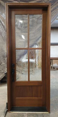 a wooden door with glass on the side