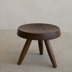 a small wooden stool sitting on top of a floor