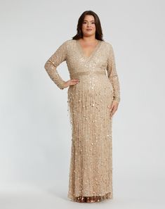 Turn heads in our Embellished Fringe Long Sleeve Gown. This stunning dress features intricate embellishments and elegant fringe, perfect for special occasions. Mac Duggal Embellished mesh fabric (100% polyester) Fully lined through bodice and skirt V-neckline Long sleeves Beaded waist/neckline Fringe detail throughout Concealed back zipper Approx. 60" from top of shoulder to bottom hem Available in Nude Gold Style #94074 Glamorous Evening Dress With Beaded Fringe For Formal Occasions, Glamorous Formal Evening Dress With Beaded Fringe, Glamorous Beaded Fringe Evening Dress For Formal Events, Elegant Evening Dress With Beaded Fringe For Prom, Elegant Beaded Fringe Evening Dress For Prom, Glamorous Embellished Mother Of The Bride Dress For Gala, Glamorous Floor-length Dress With Beaded Fringe, Evening Floor-length Dress With Beaded Fringe, Floor-length Beaded Fringe Party Dress