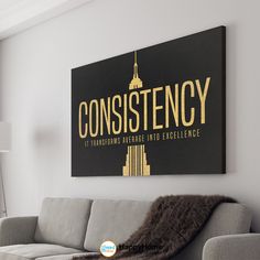 a living room filled with furniture and a large sign on the wall above it that says constistency