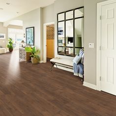 a living room filled with furniture and wooden floors