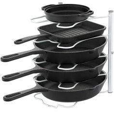 a stack of black pots and pans sitting on top of each other