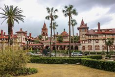 an old building with palm trees in front of it