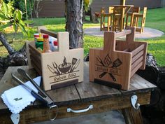 two wooden utensils are sitting on a picnic table