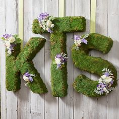 the letters are made out of moss and flowers