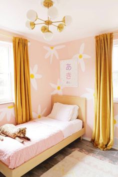 a bedroom with pink walls and yellow curtains