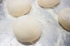 four balls of dough sitting on top of a table