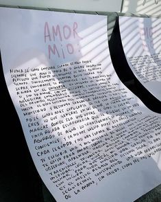 two pieces of paper with words written on them sitting next to each other in front of a building