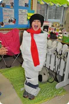 a person in a costume standing next to a fence