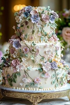 a three tiered wedding cake with flowers on it