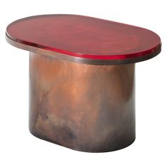 a round metal table with a red top