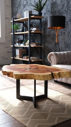 a wooden table sitting on top of a rug in a living room next to a couch