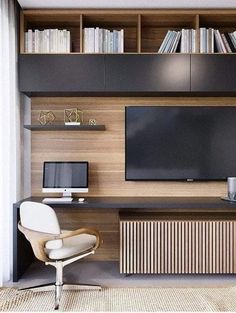 a living room with bookshelves and a television mounted on the wall next to a radiator