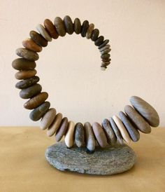 a sculpture made out of rocks sitting on top of a table