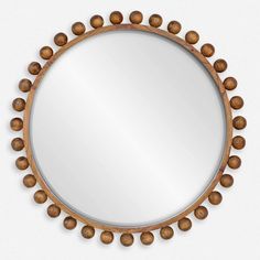 a round mirror with wooden beads on it