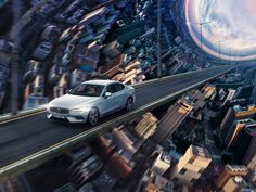 a silver car driving down a city street in the middle of an aerial view with buildings and skyscrapers