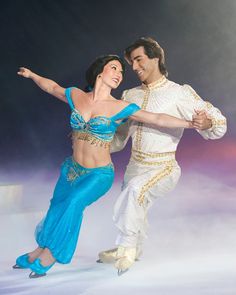 a man and woman dressed in belly dance costumes