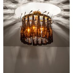 a chandelier made out of wine bottles hanging from the ceiling