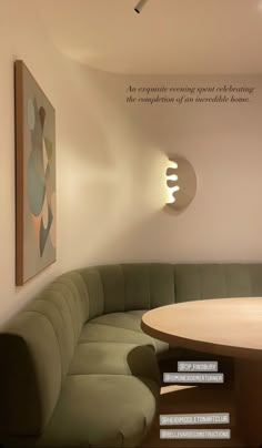 a corner couch sitting in front of a table with a quote above it on the wall