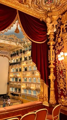 an ornately decorated theater with red curtains