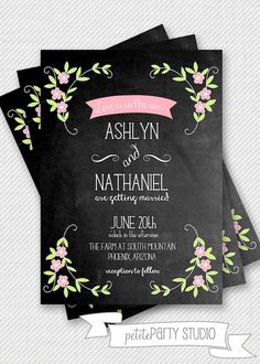 the chalkboard wedding card is shown with pink flowers and leaves on it, as well as