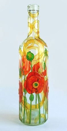 a glass bottle with flowers painted on it